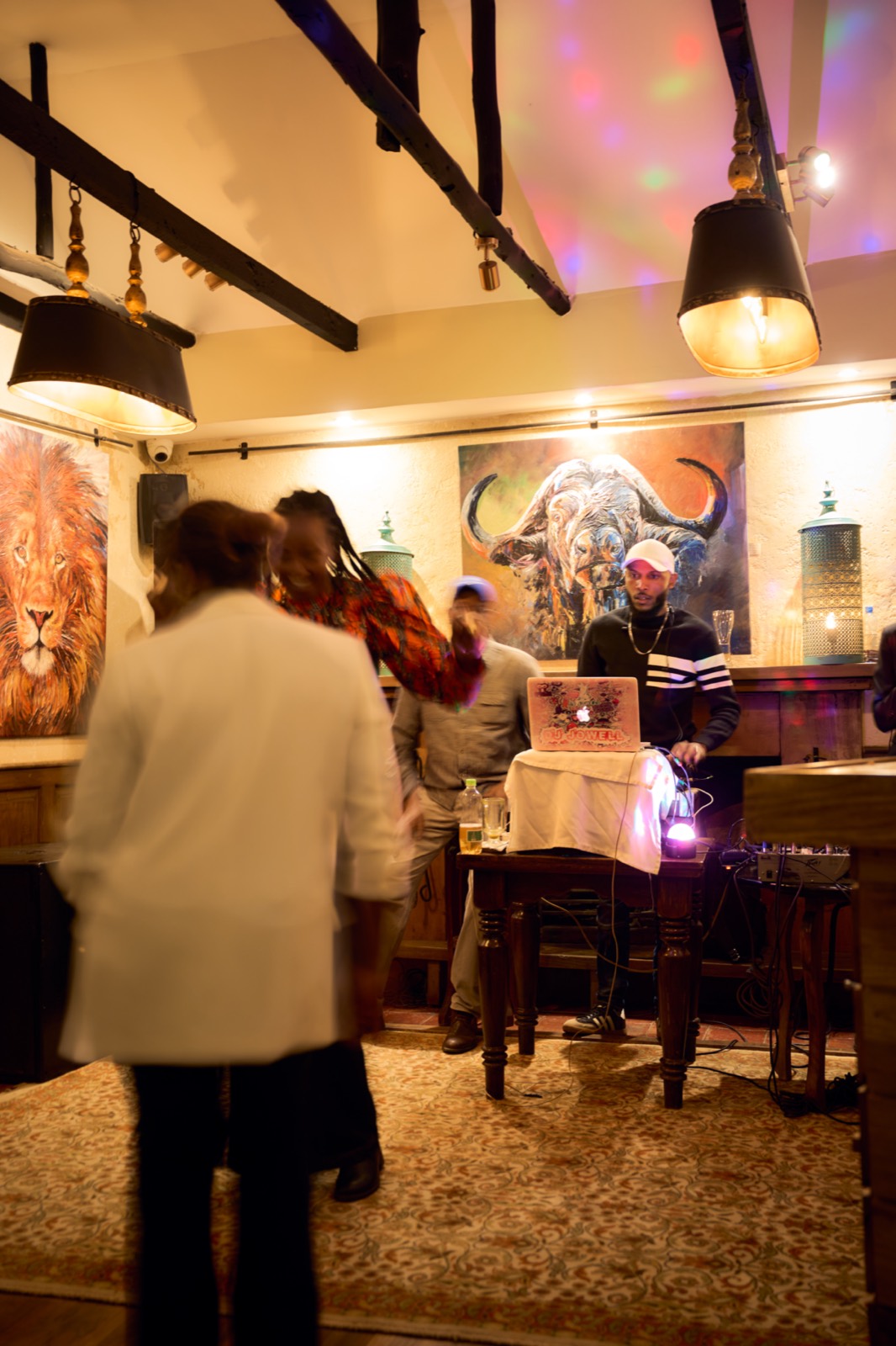 Guests beneath the changing wall art at Talisman