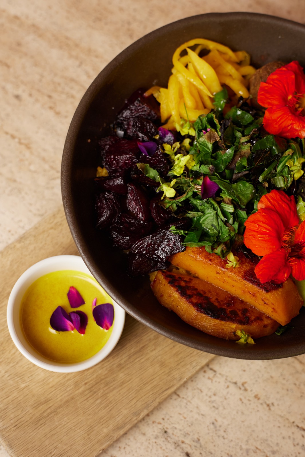 A bowl of leaves and edible flowers grown for the Talisman kitchen